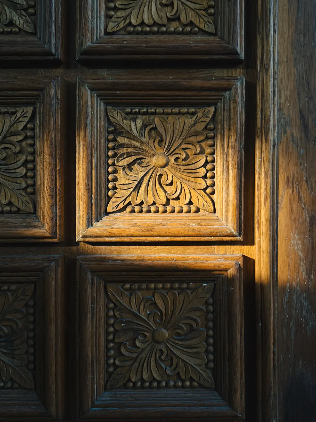 Hand-carved floral panels on a wooden door