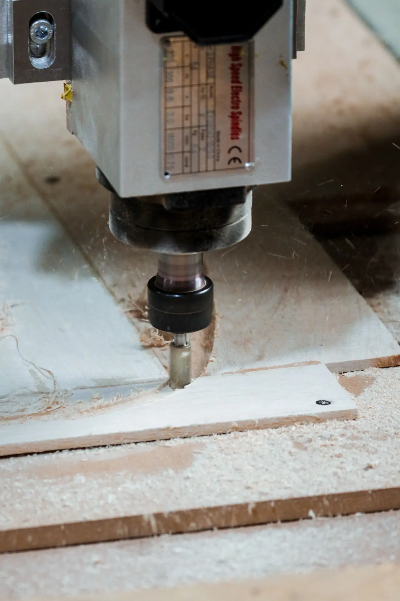 CNC spindle cutting a wooden board